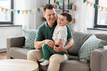 Image showing happy father and little son at home birthday party