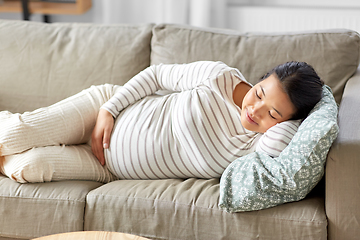 Image showing pregnant asian woman sleeping on sofa at home