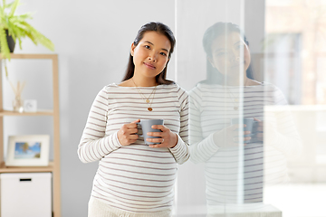 Image showing happy pregnant woman drinking tea at home