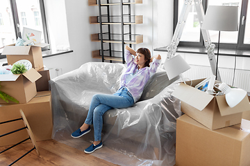 Image showing happy asian woman with stuff moving to new home