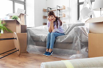 Image showing sad asian woman with stuff moving to new home