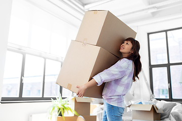 Image showing happy woman holding boxes and moving to new home