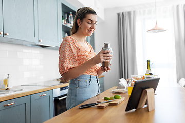 Image showing woman with tablet pc making cocktails at kitchen