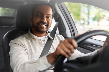 Image showing smiling indian man or driver driving car