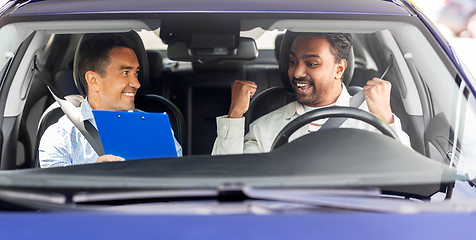 Image showing smiling car driving school instructor and driver