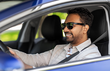 Image showing smiling indian man in sunglasses driving car