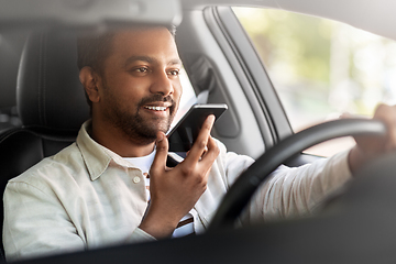 Image showing man driving car and recording voice by smartphone