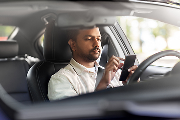 Image showing indian man in car using smartphone