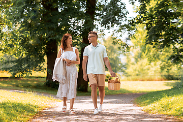 Image showing happy couple with picnic basket at summer park