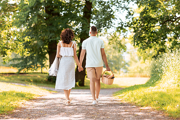 Image showing happy couple with picnic basket at summer park