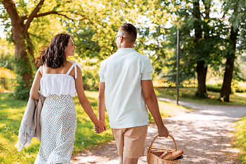 Image showing happy couple with picnic basket at summer park