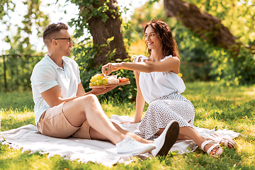 Image showing happy couple having picnic at summer park