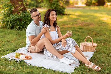 Image showing happy couple having picnic at summer park