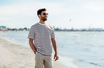 Image showing smiling young man in sunglasses on summer beach