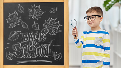 Image showing little student boy with magnifying glass