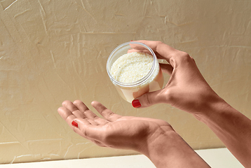 Image showing hands with bath salt in jar