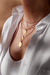Image showing close up of woman with multi layer gold chains