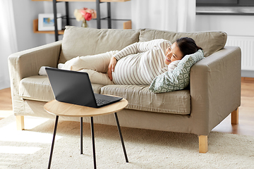 Image showing happy pregnant asian woman with laptop at home