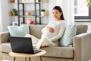 Image showing pregnant asian woman with laptop at home