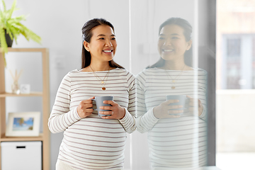 Image showing happy pregnant woman drinking tea at home