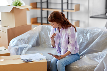 Image showing asian woman moving to new home and counting money