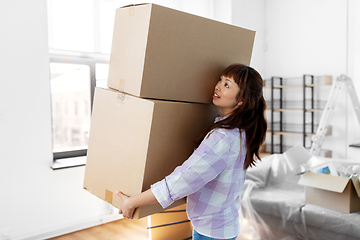 Image showing happy woman holding boxes and moving to new home