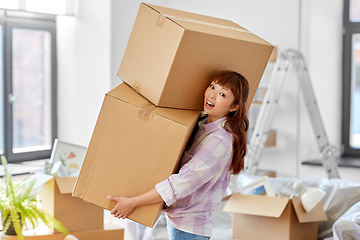 Image showing happy woman holding boxes and moving to new home