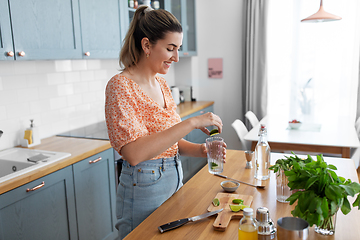 Image showing woman making cocktail drinks at home kitchen