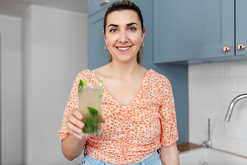 Image showing woman with lime mojito cocktail at home kitchen