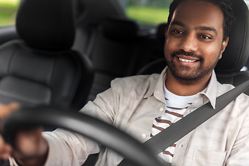 Image showing smiling indian man or driver driving car