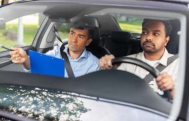 Image showing car driving school instructor and young driver