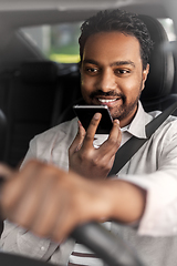 Image showing man driving car and recording voice by smartphone