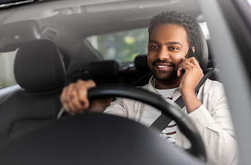 Image showing indian man driving car and calling on smartphone