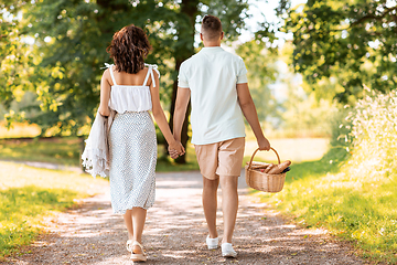 Image showing happy couple with picnic basket at summer park