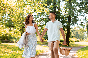 Image showing happy couple with picnic basket at summer park