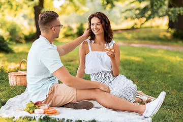 Image showing happy couple having picnic at summer park