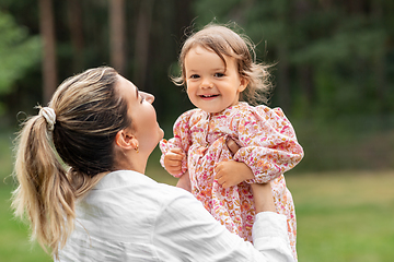 Image showing happy smiling mother with baby girl outdoors