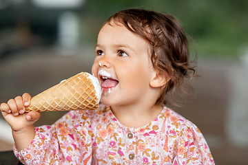 Image showing happy little baby girl eating ice cream