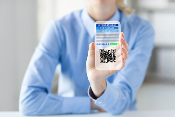 Image showing hand with virtual immunity passport on smartphone