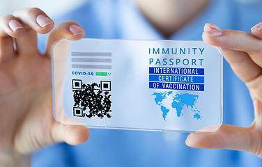 Image showing hand with virtual immunity passport on smartphone