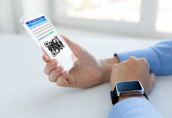 Image showing hands with virtual immunity passport on smartphone