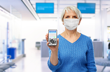 Image showing old woman with certificate of vaccination in phone