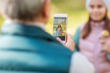 Image showing grandma photographing granddaughter with mushrooms