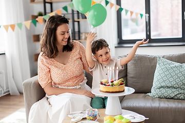 Image showing happy mother and son with birthday cake at home