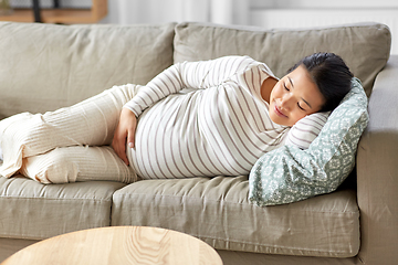 Image showing pregnant asian woman sleeping on sofa at home