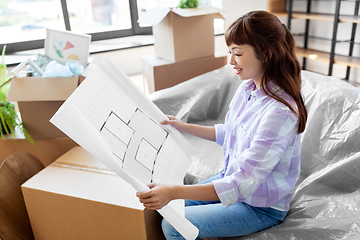 Image showing woman with blueprint and boxes moving to new home