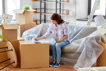 Image showing asian woman moving to new home and counting money