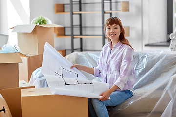 Image showing woman with blueprint and boxes moving to new home