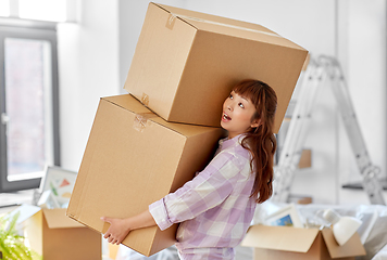 Image showing woman holding heavy boxes and moving to new home