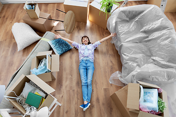 Image showing happy woman with boxes moving to new home